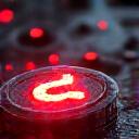 Emergency support icon: a glowing red wrench over a broken circuit board